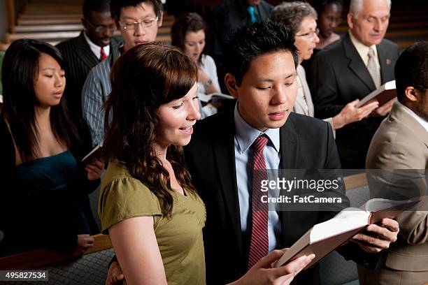 singing hymns in church - church congregation stock pictures, royalty-free photos & images