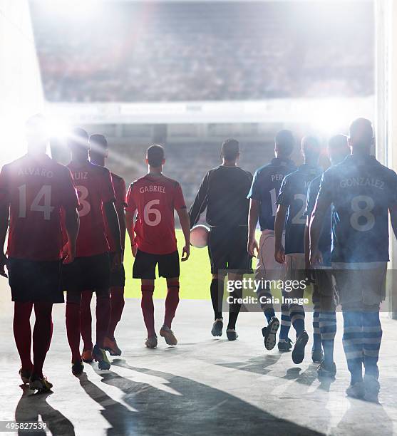 silhouette of soccer players walking to field - football player tunnel stock pictures, royalty-free photos & images