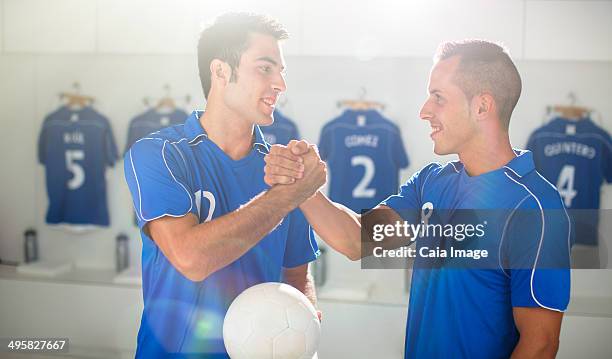 soccer players shaking hands in locker room - shaking hangs stock pictures, royalty-free photos & images