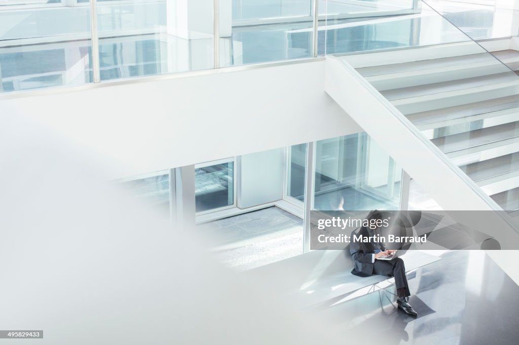 Businessman using laptop in modern office