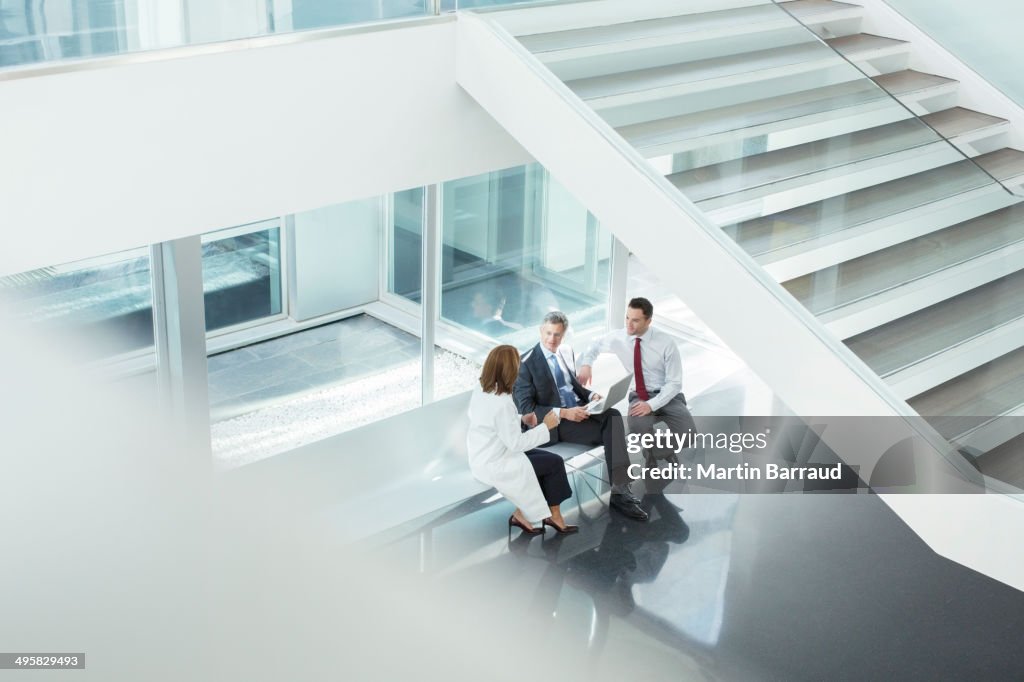Doctor and administrators talking in hospital lobby