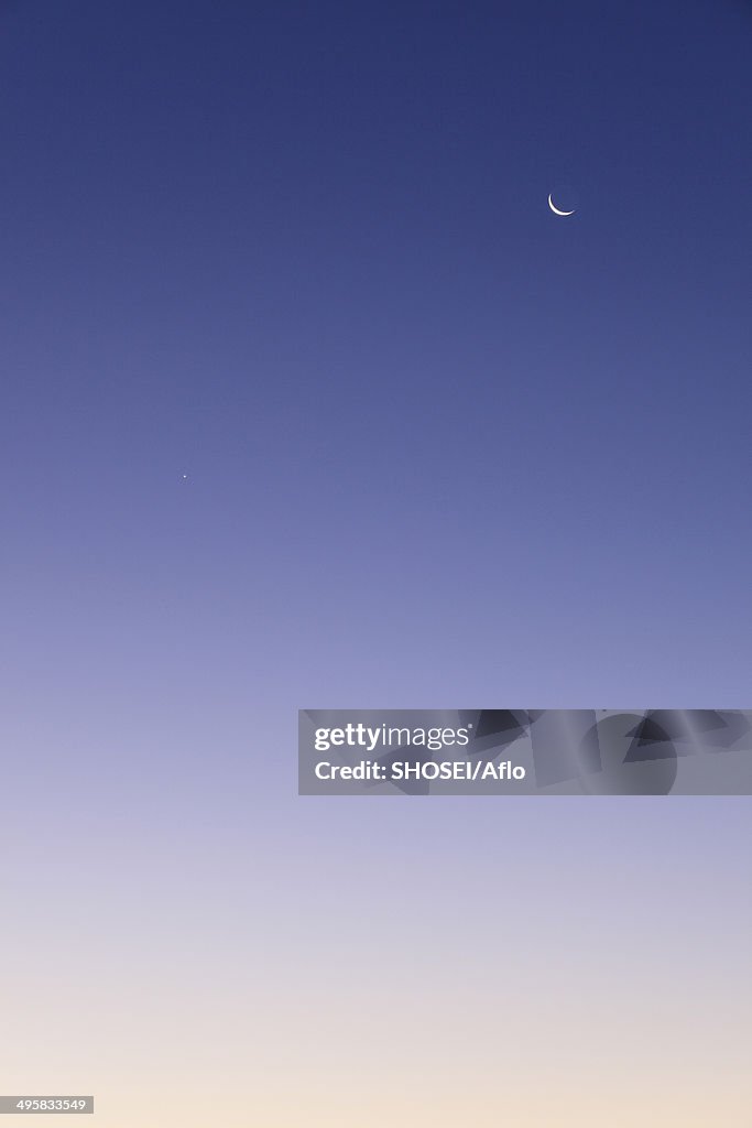 Crescent moon and dawn sky, Japan