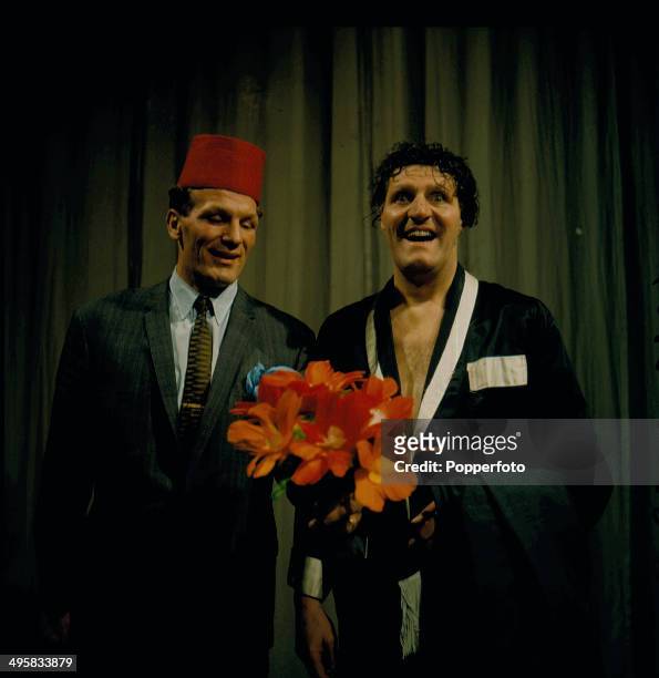 British comedian and magician Tommy Cooper right, performs in a sketch with the boxer Henry Cooper on his television series 'Cooperama' in 1966.
