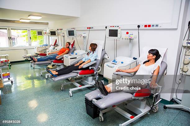 young women is going to donate blood in  blood bank - blood bank stock pictures, royalty-free photos & images