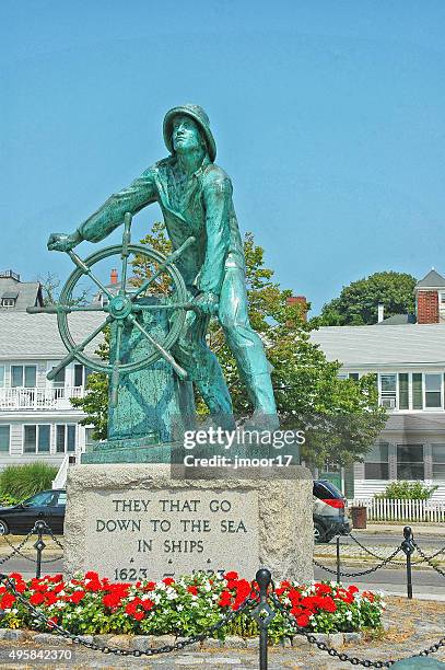 fishermans memorial with flowers in gloucester massachusetts - gloucester massachusetts stock pictures, royalty-free photos & images