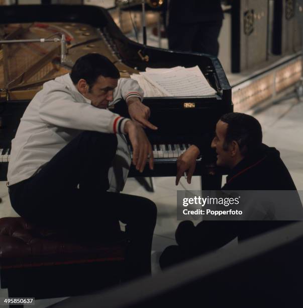 American jazz drummer Buddy Rich talks to singer Tony Bennett on the set of a television show in 1968.