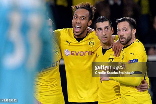 Pierre-Emerick Aubameyang celebrates with team mates Henrikh Mkhitaryan and Gonzalo Castro of Dortmund after scoring his team's second goal during...