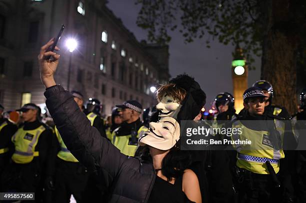 Masked protesters take a selfie in front of the Houses of Parliament during the Million Mask March on November 5, 2015 in London, England. The annual...
