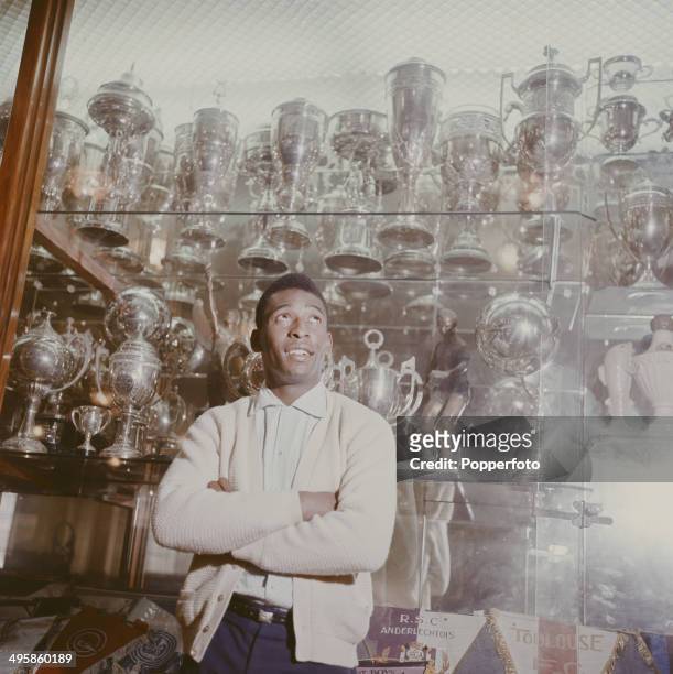 Brazilian footballer Pele pictured standing in front of the trophy cabinet at Santos FC in Santos, Brazil circa 1965.
