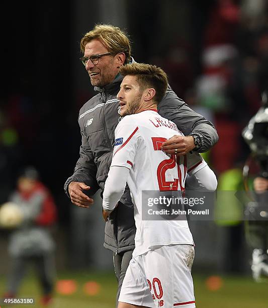 Jurgen Klopp manager of Liverpool embraces Adam Lallana at the end of the UEFA Europa League match between FC Rubin Kazan and Liverpool FC on...