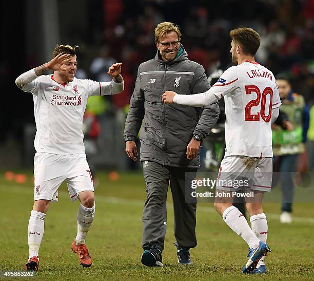 Jurgen Klopp manager of Liverpool with Alberto Moreno and Adam Lallana at the end of the UEFA Europa League match between FC Rubin Kazan and...