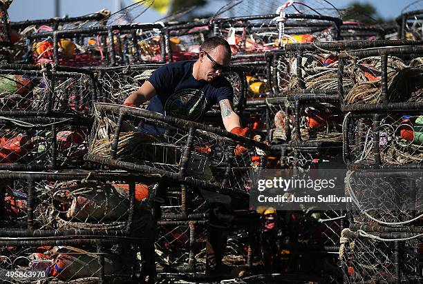 Chris Swim stacks crab traps in the parking lot of the Pillar Point Harbor on November 5, 2015 in Half Moon Bay, California. The California Fish and...
