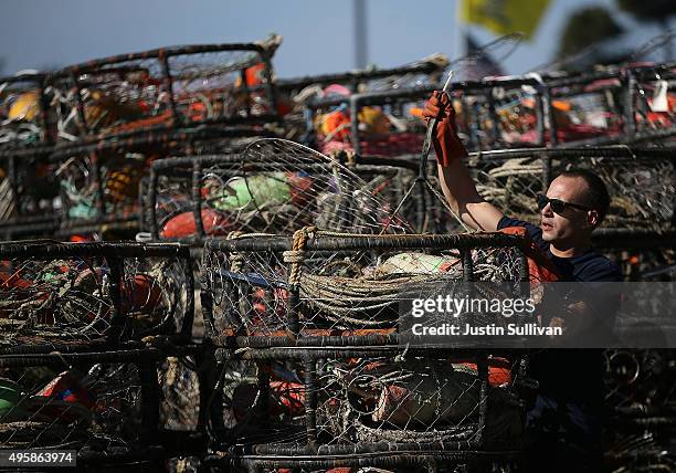 Chris Swim repairs crab traps in the parking lot of the Pillar Point Harbor on November 5, 2015 in Half Moon Bay, California. The California Fish and...