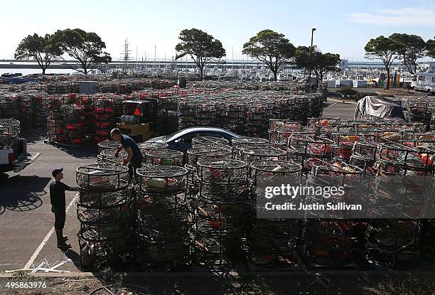 Nick White Chris Swim stack crab traps in the parking lot of the Pillar Point Harbor on November 5, 2015 in Half Moon Bay, California. The California...