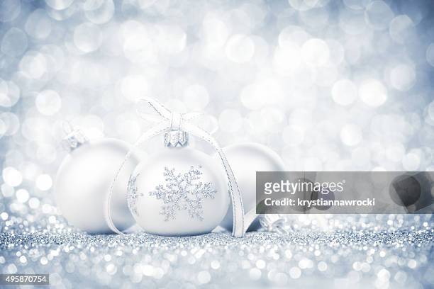 three silver bauble with snowflake decoration and ribbon on glitter - magie de noel stockfoto's en -beelden