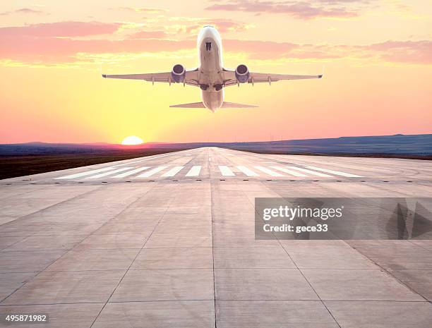 passenger airplane taking off at sunset - airport runway stock pictures, royalty-free photos & images