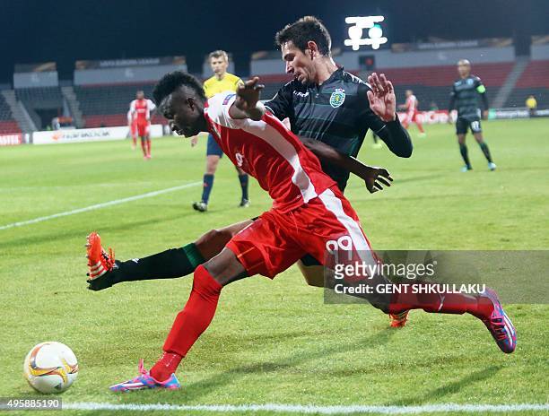 Sporting's defender Paulo Oliveira vies with Skenderbeu's forward Peter Olayinka during the Europa League football match KF Skenderbeu vs Sporting...
