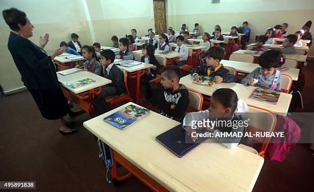 Teacher explains a lesson to students on October 26, 2015 at the Mariamana school in the multi-ethnic northern Iraqi city of Kirkuk where Kurdish,...