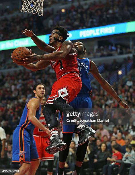 Derrick Rose of the Chicago Bulls goes up for a shot past Kevin Durant of the Oklahoma City Thunder at the United Center on November 5, 2015 in...