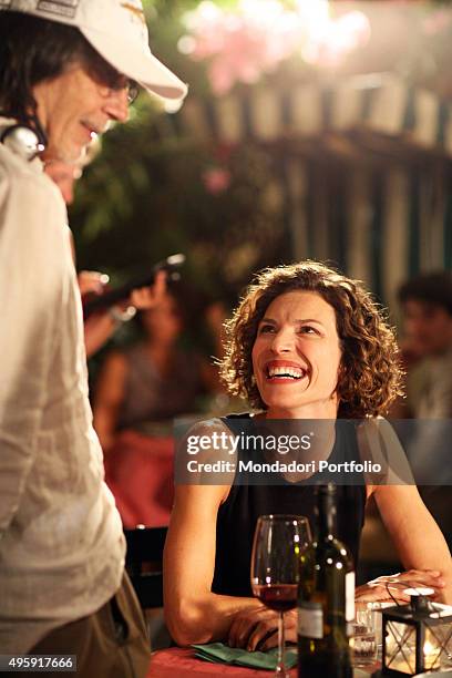 Italian actress Chiara Ricci looking smiling the Italian director Fabrizio Costa during a photo shoot realized on the set of 'Una coppia modello',...