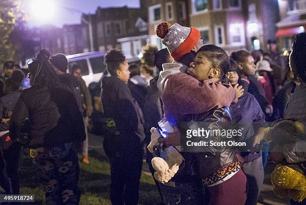 Pierre Stokes, the father of 9-year-old Tyshawn Lee, gets a hug during a candlelight vigil held outside his home in memory of his son on November 5,...