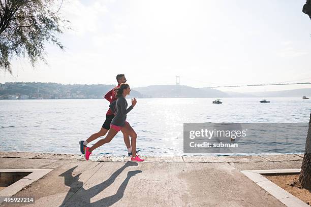 exercising makes us feel great - two women running stock pictures, royalty-free photos & images