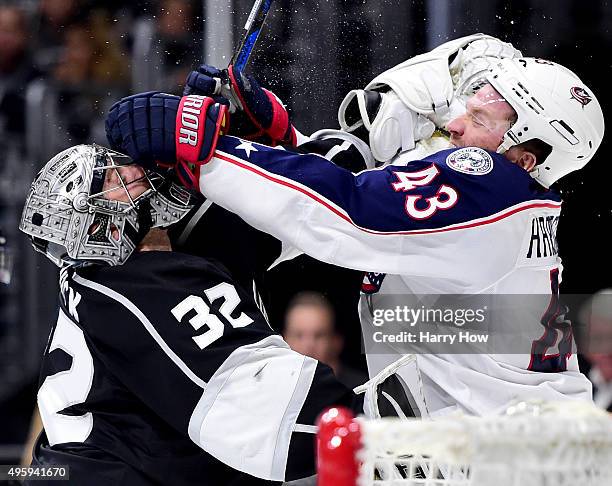 Jonathan Quick of the Los Angeles Kings and Scott Hartnell of the Columbus Blue Jackets get roughing penalties during the first period at Staples...