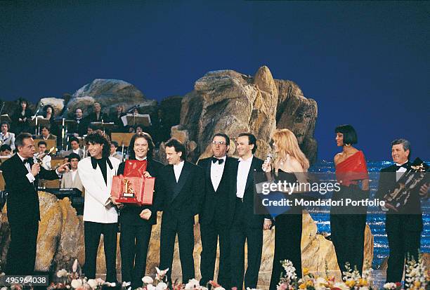 Italian band Pooh on stage during the award ceremony of the 40th Sanremo Music Festival. From the left: the Italian presenter Johnny Dorelli ,...