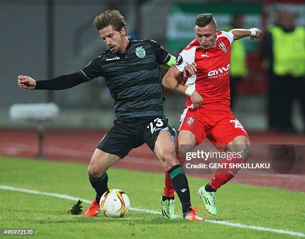 Sporting's Brazilian midfielder Adrien Silva vies with Skenderbeu's forward Bernard Berisha during the Europa League football match KF Skenderbeu vs...