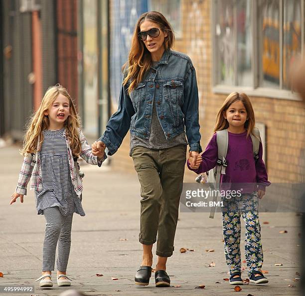Sarah Jessica Parker and twin daughters Tabitha and Marion enjoy a stroll on November 5, 2015 in New York City.