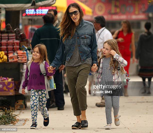 Sarah Jessica Parker and twin daughters Tabitha and Marion enjoy a stroll on November 5, 2015 in New York City.