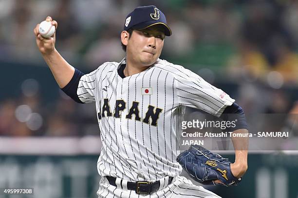 Tomoyuki Sugano of Japan pitches in the bottom half of the first inning during the send-off friendly match for WBSC Premier 12 between Japan and...