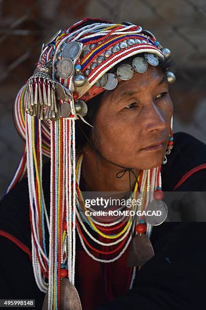 In this file photograph taken on October 22 Shan ethnic women from the Akha hill tribe wearing traditional costumes and silver head cover ornaments...