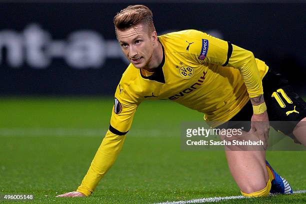 Marco Reus of Dortmund reacts after picking up an injury as he scores the opening goal during the UEFA Europa League group stage match between...