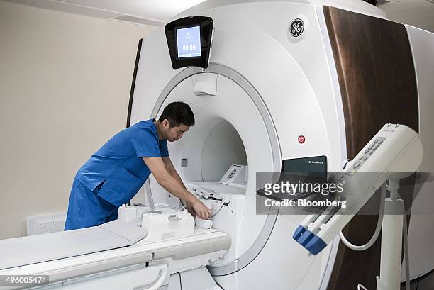 Technician prepares a General Electric Co. Magnetic resonance imaging scanner in the diagnostic imaging area at the Hong Kong Integrated Oncology...