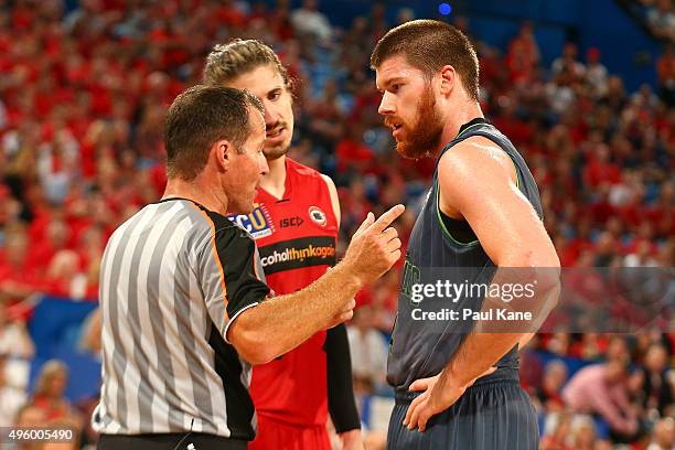 Referee Brett Hogan talks with Greg Hire of the Wildcats and Brian Conklin of the Crocodiles during the round five NBL match between Perth Wildcats...