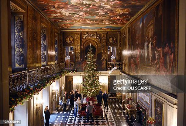 Members of the public admire the display of Christmas decorations in the Painted Hall at Chatsworth stately home near Bakewell, central England on...