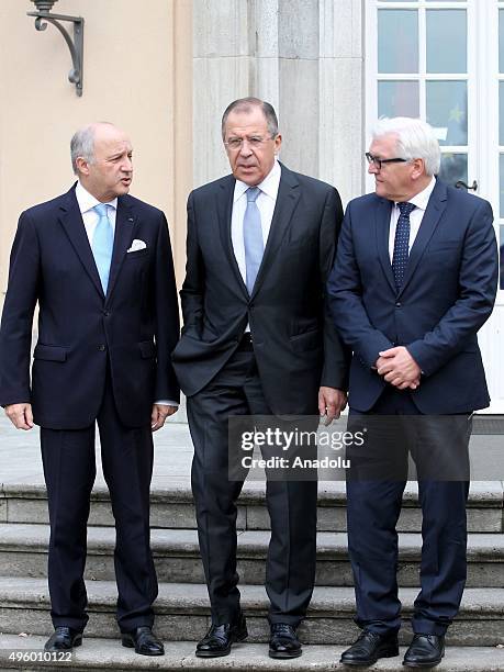 French Foreign Minister Laurent Fabius, Russian Foreign Minister Sergei Lavrov and German Foreign Minister Frank-Walter Steinmeier pose for a group...