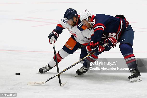 Tim Stapleton of the USA skates with Eduard Sedivy of Slovakia during match 1 of the Deutschland Cup 2015 between USA and Slovakia at...