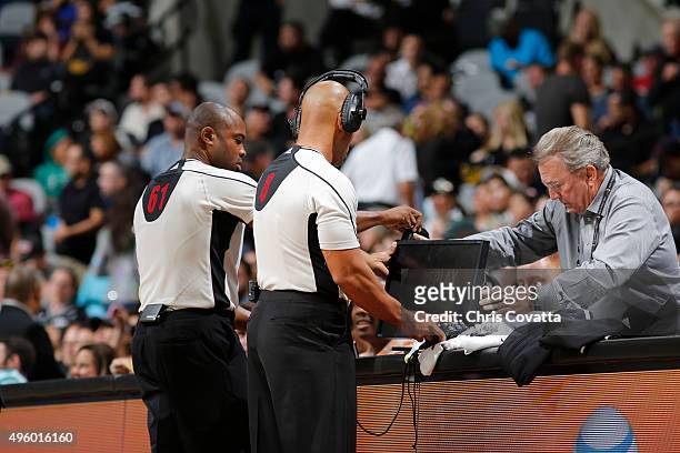 Referees Marc Davis and Courtney Kirkland use the replay monitor to review a play in the game of the Houston Rockets against the San Antonio Spurs at...