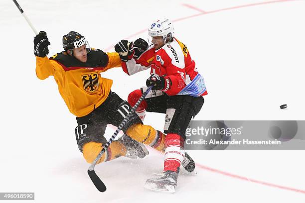 Jerome Flaake of Germany skates with Lukas Stoop of Switzerland during match 2 of the Deutschland Cup 2015 between Germany and Switzerland at...