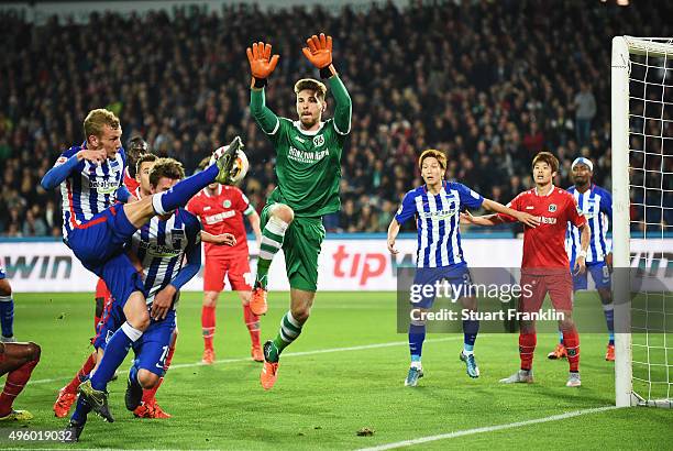 Fabian Lustenberger of Berlin has a shot saved by Ron - Robrt Zieler of Hannover during the Bundesliga match between Hannover 96 and Hertha BSC at...