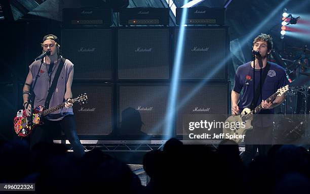 Michael Clifford and Luke Hemming from 5 Seconds of Summer perform during a live broadcast of "TFI Friday" at the Cochrane Theatre on November 6,...