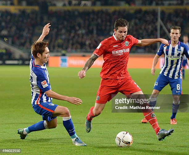 Genki Haraguchi of Hertha BSC and Leon Andreasen of Hannover 96 during the Bundesliga match between Hannover 96 and Hertha BSC at HDI-Arena on...