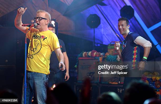 Host Chris Evans and Chris Martin from Coldplay during a live broadcast of "TFI Friday" at the Cochrane Theatre on November 6, 2015 in London,...