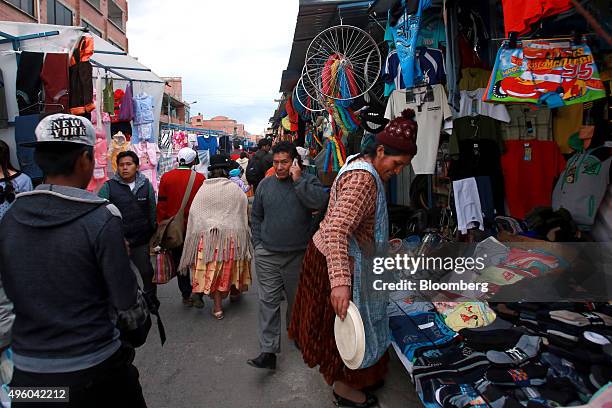 People walk through a street market in El Alto, Bolivia on Tuesday, Oct. 20, 2015. Bolivia which has experienced economic growth over the last...
