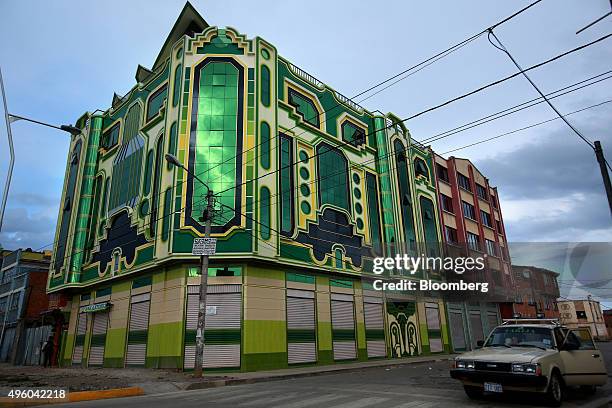 Car passes by a recently constructed building known locally as a "cholet," for its incorporation of indigenous architecture, in El Alto, Bolivia, on...