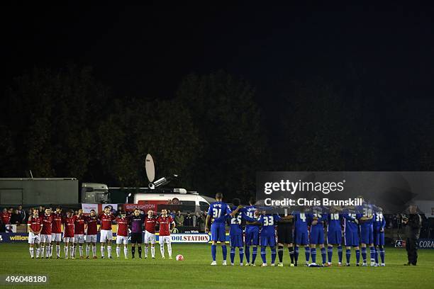 The two teams line up for a minute's silence ahead of the Emirates FA Cup First Round match between Salford City and Notts County at Moor Lane on...