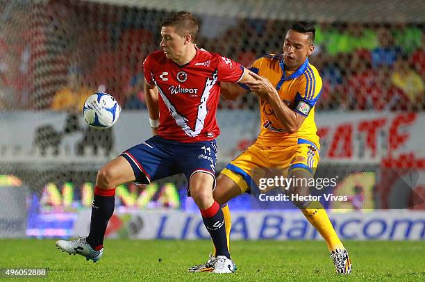 Juninho of Tigres struggles for the ball with Julio Cesar Furch of Veracruz during the 16th round match between Veracruz and Tigres UANL as part of...