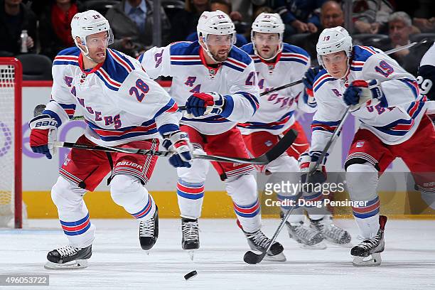 Dominic Moore, Jarret Stoll, Keith Yandle and Jesper Fast of the New York Rangers pursue the puck against the Colorado Avalanche at Pepsi Center on...